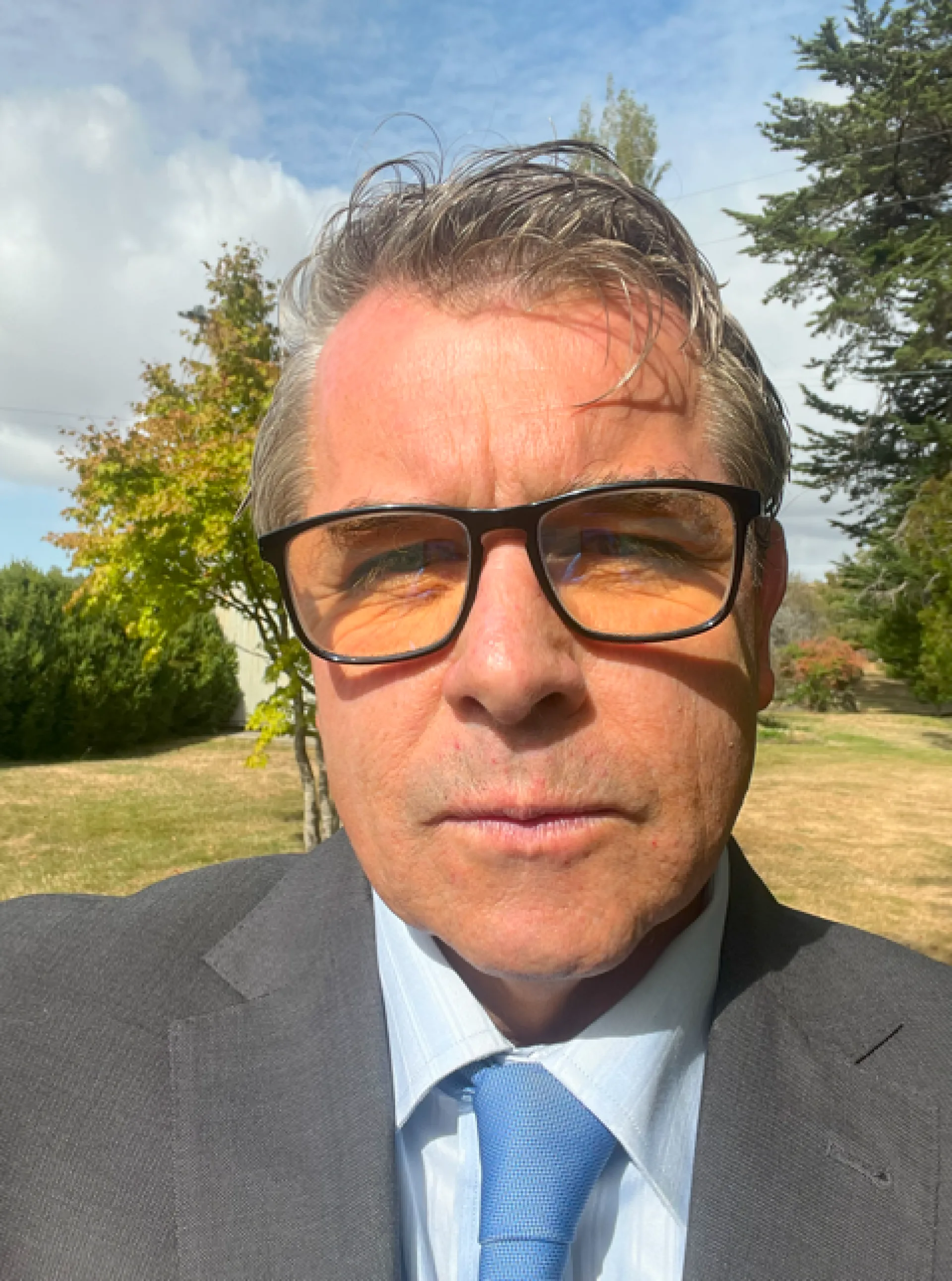 Jason in Grey Suit Blue tie on farm